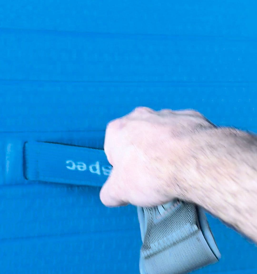 Hand gripping the soft Retrospec-branded center carry handle on the Weekender deck