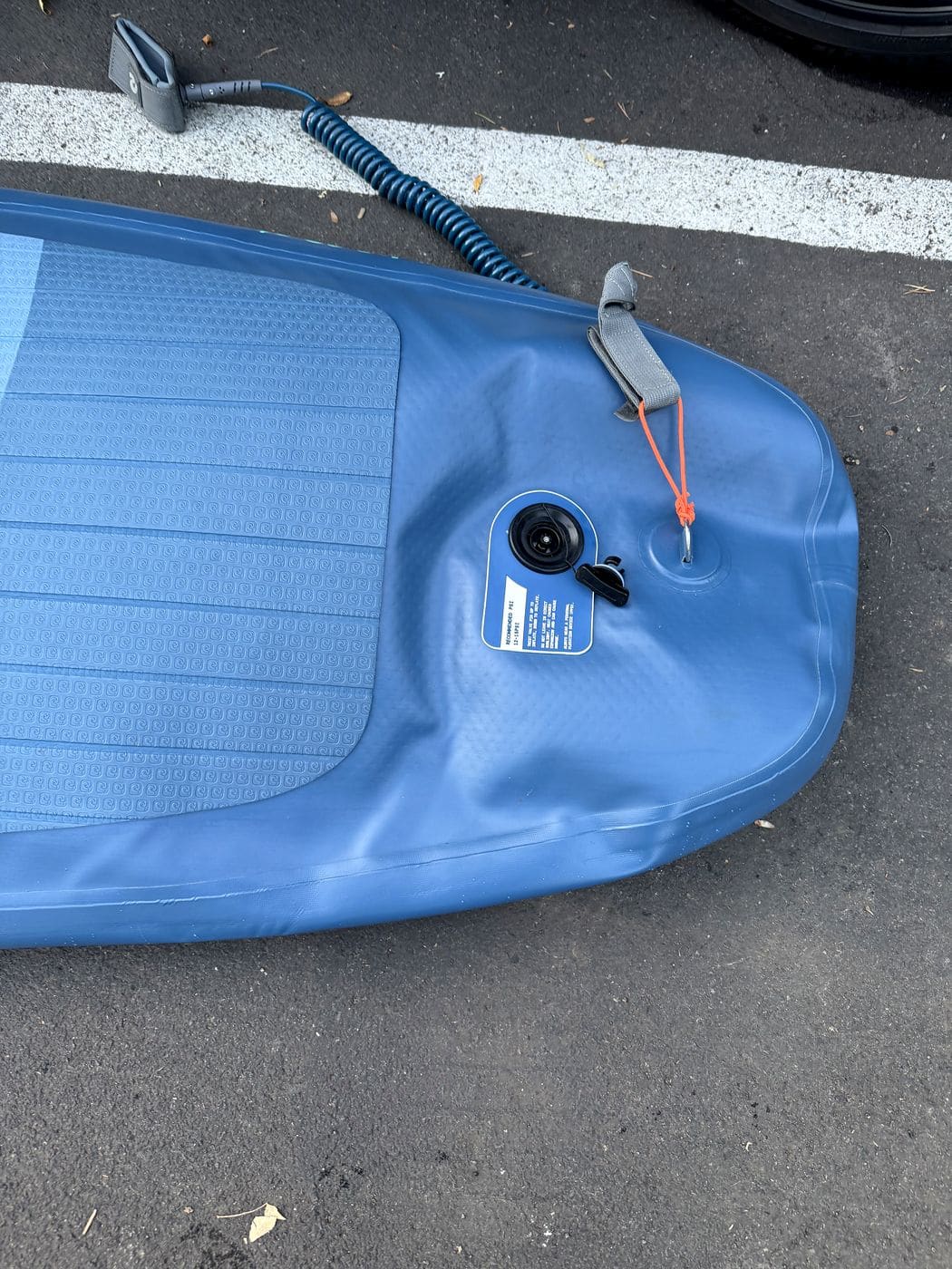 Partially deflated tail of the Weekender on the pavement with the valve open
