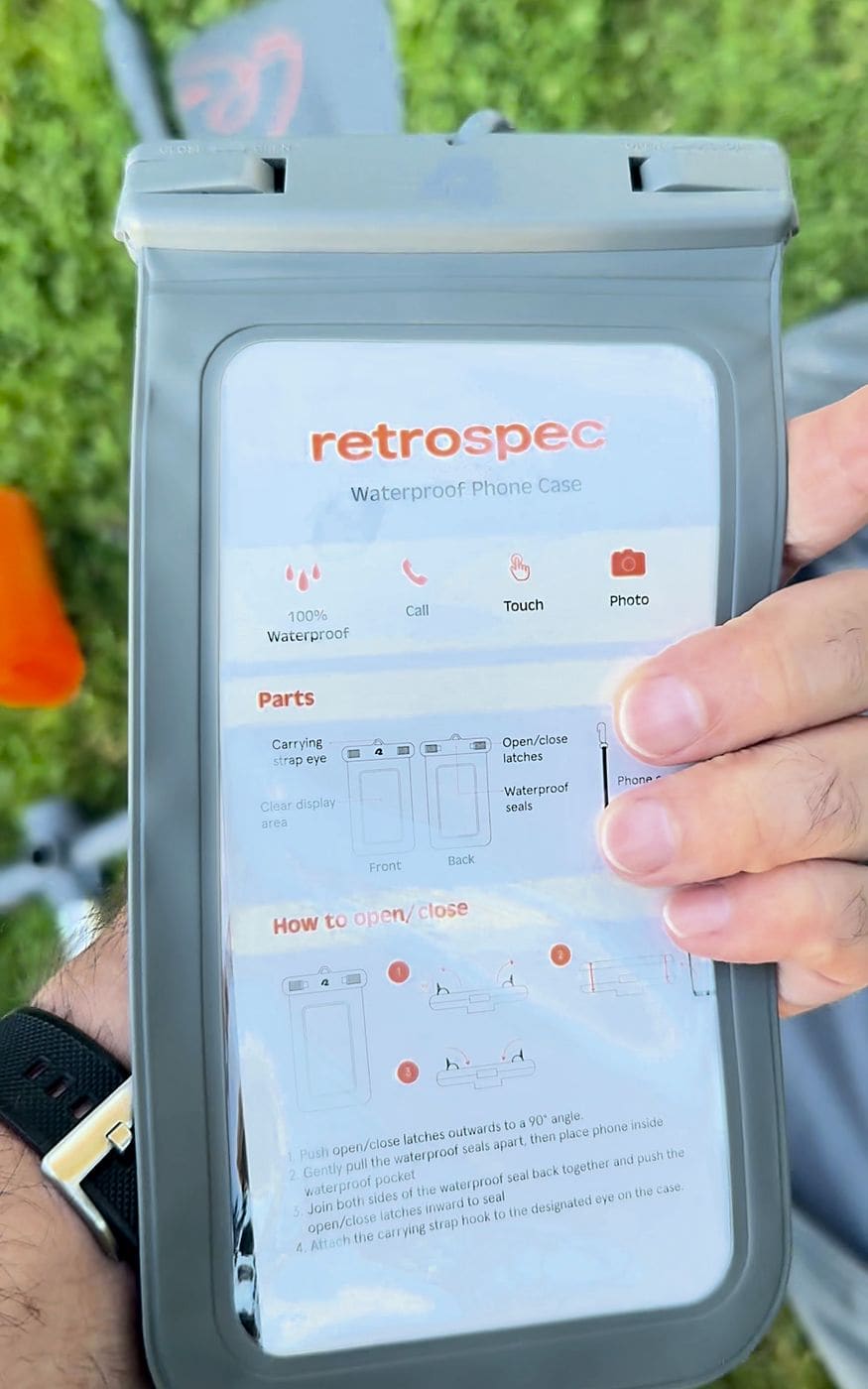 Retrospec waterproof phone case held up with the printed instruction card still inside