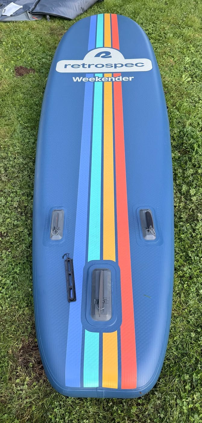 Underside of the Retrospec Weekender showing the full-length rainbow stripes, the Retrospec Weekender logo and the three fin boxes